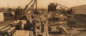 [SYDNEY HARBOUR BRIDGE INTEREST] Panoramic photograph from two gelatin silver prints, laid down on original board with mount, accompanied by contemporary card inscribed "Loading blocks of granodiorite to be used in constructing the pylons of the harbour b