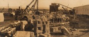 [SYDNEY HARBOUR BRIDGE INTEREST] Panoramic photograph from two gelatin silver prints, laid down on original board with mount, accompanied by contemporary card inscribed "Loading blocks of granodiorite to be used in constructing the pylons of the harbour b