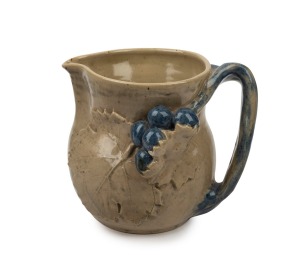 MERRIC BOYD pottery jug with applied grapes and branch handle highlighted in blue glaze, incised "Merric Boyd, 1930", ​​​​​​​14cm high.