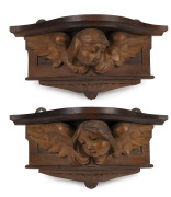 PRENZEL pair of carved architectural cherub wall brackets, signed "R. Prenzel", 16cm high, 36cm wide, 15cm deep.