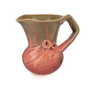 REMUED rare pink and olive green glazed pottery jug with applied gumnuts, leaves and branch handle, 12cm high.