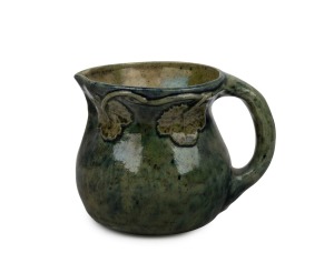 MERRIC BOYD green glazed pottery jug with applied grape leaves and vine motif, incised "Merric Boyd, 1928", 10.5cm high.