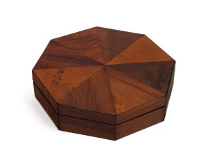 H. W. BROUGHTON of MELBOURNE rare Colonial Australian octagonal trinket box, circa 1850, bearing original paper label "R. W. Broughton, Fancy Cabinet Maker, Melbourne", with original blue paper lining and handwritten manuscript key of the timber veneers "Huon pine, She-oak, He-oak, Black Pine, Honeysuckle, Red Gum, Cypress Pine, Tulip". Base with original patterned paper lining with additional scarlet paper manuscript key. 5cm high, 20cm wide, 20cm deep.