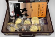 A good quality briefcase containing a diverse range, including 1997 Australian $5 with HK serials Unc in folder; 1998 $20 Uncut blk.4 in special folder (U22d); various world banknotes; ANZACS Remembered, and ANZAC to AFGHANISTAN coin sets in folders, plus