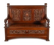 R. G. KIRKHAM antique Australian blackwood hall seat with lift-top storage box base. Impressively carved with griffin heads, pomegranates and fish scale borders, early 20th century, ink stamp to the interior "R. & G. Kirkham, 22 Latrobe Parade, Melbourne"