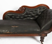 An antique Australian cedar chaise longue with scroll back and end rests, decorated with applied rosette rondels, on faceted baluster legs and original brass castors. Retaining antique leatherette diamond button upholstery, original colour, finish and pat - 2