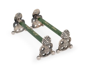 A pair of antique English sterling silver and New Zealand greenstone knife rests with Tiki ends, made in Birmingham, circa 1913, 3cm high, 7cm wide.
