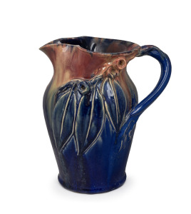 REMUED blue and pink glazed pottery jug with applied gumnuts, leaves and branch handle, incised "Remued, Hand Made 54LM", 25.5cm high.