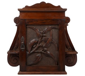 333 · An antique Australian kauri pine wall mounted cabinet, attractively adorned with carved gumnuts, leaves and branches, 19th/20th century, 46cm high, 52cm wide, 16cm deep.