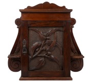 An antique Australian kauri pine wall mounted cabinet, attractively adorned with carved gumnuts, leaves and branches, 19th/20th century, 46cm high, 52cm wide, 16cm deep.