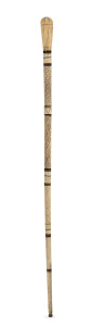 An antique whalebone walking stick with baleen spacers and carved whale's tooth top, 19th century, 78.5cm high.
