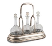 WENDT rare South Australian silver three bottle decanter stand, 19th century, stamped "J.M. WENDT, ADELAIDE" with lion passant, crown and monarch's head, ​​​​​​​35cm high, 40cm wide overall.