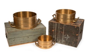 An exceptional set of three Imperial Standard measures, Bushel, Half Bushel and Peck, solid cast brass, 19th century, engraved "VICTORIA, J. M'EWAN & Co. LONDON AND MELBOURNE", housed in two original timber cases, Bushel measure 24cm high, 67cm across the handles.