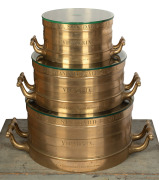 An exceptional set of three Imperial Standard measures, Bushel, Half Bushel and Peck, solid cast brass, 19th century, engraved "VICTORIA, J. M'EWAN & Co. LONDON AND MELBOURNE", housed in two original timber cases, Bushel measure 24cm high, 67cm across the - 2
