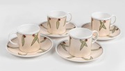E. M. WARBURTON set of four hand-painted porcelain coffee cups and saucers, decorated with gumnuts and leaves on Susie Cooper blanks, (8 items)