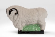 A ceramic merino ram statue, 16cm high, 23cm long