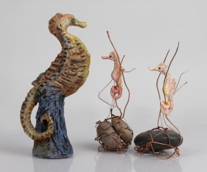 Three studio pottery seahorse ornaments, two with stone and copper wire adornment, the largest 22cm high