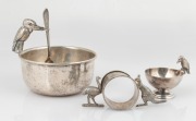Australiana silver plated kookaburra sugar bowl with spoon, salt cellar and napkin ring, early 20th century, (4 items), the largest 10cm high