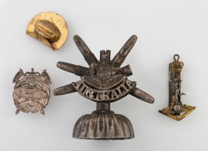A trench art desk ornament, an Australian tank battalion hat badge, a slouch hat gilt metal pendant with military photo portrait on the reverse and an Australian badge, 20th century, (4 items), ​​​​​​​the largest 9cm high