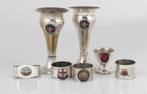 Australian silver plated vases, napkin rings and egg cup, each decorated in enamel, early to mid 20th century, (7 items), the vases 14cm high.