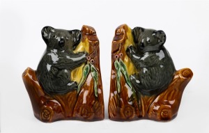 A pair of ceramic koala bookends with applied gumnuts and leaves, 13cm high.