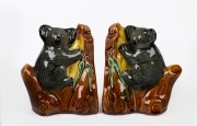 A pair of ceramic koala bookends with applied gumnuts and leaves, 13cm high.