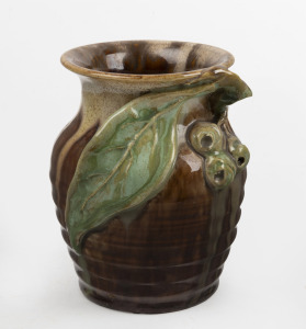 REMUED brown and green glazed pottery vase with applied gumnuts, leaf and branch handle, incised "Remued", 10cm high.