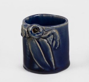 REMUED blue glazed miniature pottery vase with applied gumnut, leaf and twig decoration, incised "Remued", 5.5cm high.