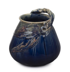 REMUED rare blue glazed pottery vase with pink blush highlights, unusual applied gum leaves, gumnuts and branch handle with further vertical linear decoration to the body, incised "Remued", 17cm high.