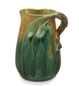 UNA DEERBON stunning green and yellow glazed pottery jug with applied gum leaves, gumnuts and branch handle, incised "Deerbon", 21.5cm high.