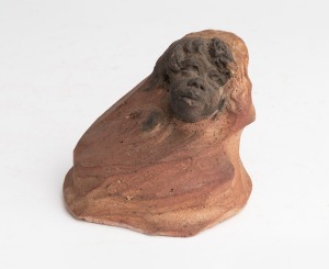 WILLIAM RICKETTS pottery sculpture with a young Aboriginal face, inscribed verso "See what work with ochre had ...", incised "Wm. R.", 8cm high.