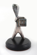 T.V. WEEK "SILVER LOGIE" on ebonized timber plinth, ​​​​​​​20cm high.