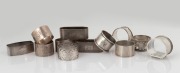 Twelve assorted antique and vintage Australian silver napkin rings (one boxed), makers include MOLE of Brisbane, F. & W. STEWART of Launceston, PIPER of Melbourne, and others, 19th/20th century, ​​​​​​​355 grams total.