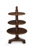 A rare antique Australian cedar graduated circular three tier dumbwaiter with tri-form base, squat bun feet with concealed castors and central column terminating with a cedar acorn finial, circa 1850. Note: This form of dumbwaiter is very seldom seen in A