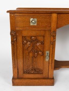 ROBERT PRENZEL antique Australian oak single pedestal hall table with carved waratah decoration to the corners and gumnut and gum leaf carving to the stippled panel door, original nickle plated hardware, tapering legs and lower footrest shelf, the side of - 2