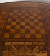 PETER McCANN (1828-1908) of TORQUAY VICTORIA: Unique and interesting user-made games table on turned blackwood stretcher base and with single frieze drawer, the oval top with parquetry chess and cribbage inlay of numerous Victorian specimen timbers includ - 2