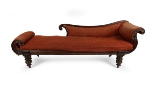 268 · An early Colonial Australian cedar chaise lounge with cross-banded and carved facings, reeded blocks and paterae, vase turned legs with original brass castors, and very rare original leather strapping, Northern Tasmanian origin, circa 1830,