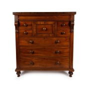 An antique Australian cedar chest of eight drawers with handsomely carved corbels and cross banded edge, top drawer with secret locking mechanism, 19th century, paper label affixed to the carcass beneath the hat drawer "FROM SAMUEL SMITH'S CABINET, UPHOLS