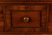 An antique Australian cedar chest of eight drawers with handsomely carved corbels and cross banded edge, top drawer with secret locking mechanism, 19th century, paper label affixed to the carcass beneath the hat drawer "FROM SAMUEL SMITH'S CABINET, UPHOLS - 4
