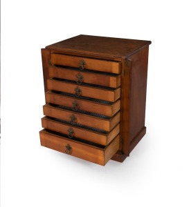 157 · An antique Australian stained kauri pine seven drawer miniature stationary chest in the Wellington style, 19th century, 54cm high, 43cm wide, 33cm deep.