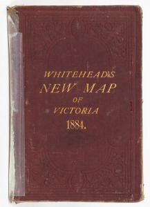 Whitehead's New Map of Victoria 1884, laid down on linen and folded within the original claret boards (spine repaired) with gilt lettering. 43 x 58cm (opened out).