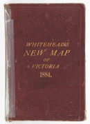 Whitehead's New Map of Victoria 1884, laid down on linen and folded within the original claret boards (spine repaired) with gilt lettering. 43 x 58cm (opened out).