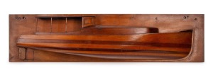 Half hull model boat with open cabin, cedar and pine mounted on pine board, early 20th century, pencil inscription verso "Martindale, Sept. 1928" 18 x 75cm.