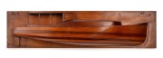 Half hull model boat with open cabin, cedar and pine mounted on pine board, early 20th century, pencil inscription verso "Martindale, Sept. 1928" 18 x 75cm.