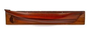 Half hull model boat, cedar and pine laminated construction mounted on white cedar board, 19th/20th century, 17 x 83cm.