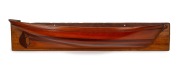 Half hull model boat, cedar and pine laminated construction mounted on white cedar board, 19th/20th century, 17 x 83cm.