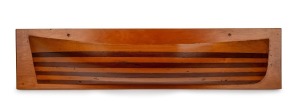 Half hull boat model, cedar and pine laminated construction on kauri pine back board, 19th/20th century, 18 x 77cm.