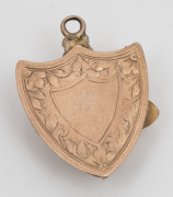An antique shield shaped gold and diamond cross pick and shovel miner's pendant, 19th century, ​​​​​​​3cm high, 3.7 grams total including stones. - 2