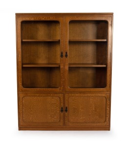 An antique Australian Queensland maple bookcase by DAVID BELL, 152.5cm high, 122cm wide, 29cm deep.