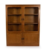 An antique Australian Queensland maple bookcase by DAVID BELL, 152.5cm high, 122cm wide, 29cm deep.